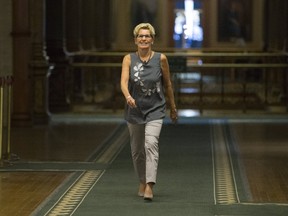 Premier Kathleen Wynne walks down the hall inside Queen's Park on Thursday, Aug. 17, 2017. (STAN BEHAL/TORONTO SUN)