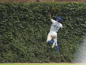 Kevin Pillar of the Toronto Blue Jays fields a fly ball off the center field wall during the eighth inning of a game against the Chicago Cubs at Wrigley Field on Aug. 20, 2017. (Stacy Revere/Getty Images)