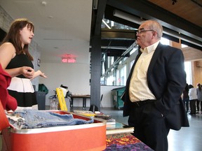 Emma Fraser-Ellott chats with deputy mayor Al Sizer about her business EFE Vintage at a special  event last Wednesday in which eight young entrepreneurs were recognized after successfully completing the Summer Company Program. (Gino Donato/Sudbury Star)