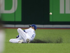 Jose Bautista of the Toronto Blue Jays slides but cannot catch a bloop RBI single by Eduardo Nunez of the Boston Red Sox in the sixth inning during MLB action at Rogers Centre on Aug. 29, 2017. (Tom Szczerbowski/Getty Images)