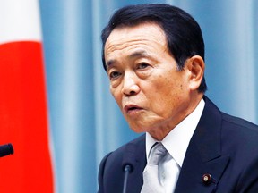Finance Minister Taro Aso speaks during a press conference at Prime Minister Shinzo Abe's official residence in Tokyo, Wednesday, Sept. 3, 2014. Japan appointed five women to the 18-member Cabinet on Wednesday in a small but symbolic step toward gender equality in government, which remains male dominated in many nations. (AP Photo/Shizuo Kambayashi)