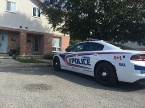 A police cruiser remained parked outside a Wavell Street complex Wednesday. (DALE CARRUTHERS, The London Free Press)
