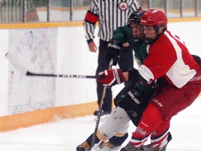 Wallaceburg Lakers prospect Zak Mainville battle for the puck against a North Middlesex player at Walpole Island Sports Complex on Friday. The Lakers play another exhibition game on Walpole Island on Sept. 2 against Blenheim