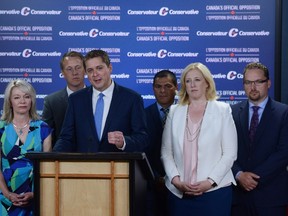 Leader of the Official Opposition and Leader of the Conservative Party of Canada, Andrew Scheer, makes an announcement and holds a media availability as he stands with his team at the National Press Theatre in Ottawa on Thursday, July 20, 2017. THE CANADIAN PRESS/Sean Kilpatrick