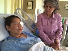 Marlene Bird (left) rests in hospital with her aunt Lorna Thiessen after she was attacked and burned in 2014. (Postmedia Network/Files)