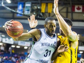 Kirk Williams Jr. of the Niagara River Lions runs the ball past Julian Boyd of the London Lightning during their game at the Meridian Centre in downtown St. Catharines on Thursday, February 9, 2017. (Postmedia Network)