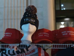 This file photo taken on January 20, 2017 shows hats displayed for sale on the morning of Donald Trump's inauguration as the 45th President of the United States in Washington, DC. A misconduct hearing opened on August 23, 2017 into a Canadian judge's wearing of a "Make America Great Again" campaign cap in court the day after Donald Trump was elected US president last November. Judges in Canada are forbidden from expressing partisan political views as a way of ensuring the appearance of their independence.Ontario Court Justice Bernd Zabel said wearing the red cap bearing Trump's campaign slogan was meant as a dig at colleagues who had supported Trump's rival for the US presidency, Hillary Clinton. (MOLLY RILEY/AFP/Getty Images)
