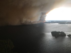 Photo of Wasagamack fire taken by pilot over Island Lake. Around 3,000 residents of Wasagamack, St. Theresa Point and Garden Hill first nations were evacuated to Brandon and Winnipeg, it was announced on Wednesday, Aug. 30, 2017 at a press briefing in Winnipeg. HANDOUT/Government of Manitoba
