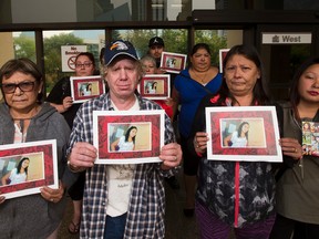 Friends and family of Lena Steinhauer hold her picture outside the Edmonton courthouse on Wednesday August 30, 2017. In the front row is Helen Larson, Gregory Locher, mother Sheila Steinhauer and cousin, Denise Steinhauer. On February 9 2015, police were called to a home at 112 Avenue and 95A Street after someone found Steinhauer’s body inside. Greg Southam / Postmedia