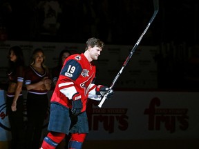 Shane Doan acknowledges the crowd during a ceremony honoring Doan for his 400th NHL goal and his 1500th NHL game played prior to an NHL hockey game against the New York Islanders, in Glendale, Ariz. Doan is retiring after 21 seasons with the same franchise.