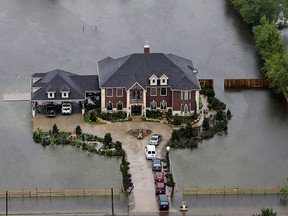 A home is surrounded by floodwaters from Tropical Storm Harvey on Tuesday, Aug. 29, 2017, in Houston. (AP Photo/David J. Phillip)