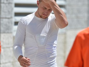 In this Aug. 4, 2015, file photo, Cleveland Browns quarterback Johnny Manziel reacts after practice at NFL football training camp, in Berea, Ohio. (AP Photo/David Richard)