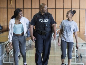 Toronto Police Const. Alphonso Carter walks the halls of Cardinal Newman High School greeting and talking with students on Monday, June 12, 2017. Carter is a school resource officer at Cardinal Newman. (Craig Robertson/Toronto Sun)