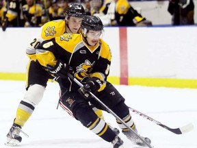 Team Black's Nash Nienhuis (5) is chased by Team White's Jordan Ernst (20) during the Sarnia Sting's Black & White intrasquad game at Progressive Auto Sales Arena on Wednesday, Aug. 30, 2017. Mark Malone/Postmedia Network