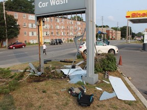 A vehicle crashed into a traffic light pole and the gas station sign at Adelaide and Cheapside streets Thursday morning. CHARLIE PINKERTON / THE LONDON FREE PRESS