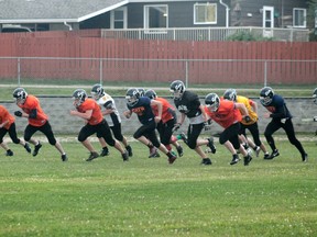 Whitecourt Cats players dash across the football field during their first week of practice for the season at Hilltop High School on Aug. 24. (Jeremy Appel | Whitecourt Star).