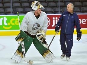 Knights goaltender Tyler Johnson with goaltending coach Dave Rook during practice at Budweiser Gardens. MORRIS LAMONT/THE LONDON FREE PRESS /POSTMEDIA NETWORK