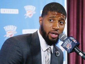 In this July 12, 2017, file photo, Oklahoma City Thunder forward Paul George answers a question at his first news conference since Oklahoma City's blockbuster trade with the Indiana Pacers, in Oklahoma City. (AP Photo/Sue Ogrocki, File)