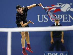 Denis Shapovalov serves to Jo-Wilfried Tsonga at the U.S. Open tennis tournament in New York on Aug. 30, 2017. (AP Photo/Kathy Willens)