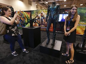 Jenn Clarke takes a picture of Lorin Adams in front of Cate Blanchett's Hela headpiece and costume from the upcoming Marvel blockbuster Thor Ragnarok. The costume will be on display all weekend at Fan Expo Canada, being held at the Metro Toronto Convention Centre. (JACK BOLAND/TORONTO SUN)