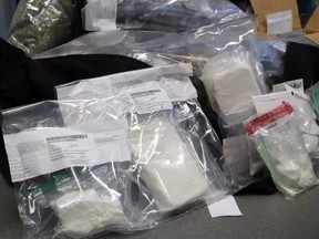 Stony Plain/Spruce Grove/Enoch RCMP seized nearly $700,000 worth of drugs, including carfentanil, two guns, $45,000 in cash, a silver bar and gold coins from a residence in west Edmonton on Friday, Aug. 25, 2017.  JESSE COLE / POSTMEDIA
