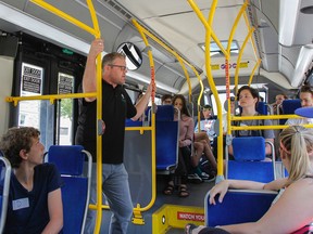 Dan Hendry, sustainable initiative co-ordinator with the Limestone District School Board, gives a group of Grade 9 students from Kingston Collegiate an overview of bus etiquette and how to use their new transit card during a short ride around the area during the school’s orientation on Thursday. (Julia McKay/The Whig-Standard)
