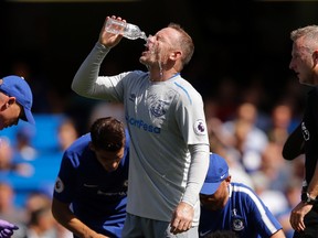 Everton's Wayne Rooney pours water on his face during the English Premier League soccer match between Chelsea and Everton at Stamford Bridge stadium in London, Sunday, Aug. 27, 2017. (AP Photo/Alastair Grant)