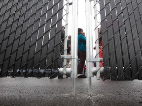 Refugees who crossed the Canada-U.S. border illegally wait in a temporary detention centre in Blackpool, Quebec, on August 5, 2017. (GEOFF ROBINS/AFP/Getty Images)