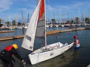 Rolling a boat off a trailer is the first step to getting on the water for sail training.NEIL BOWEN/Sarnia Observer