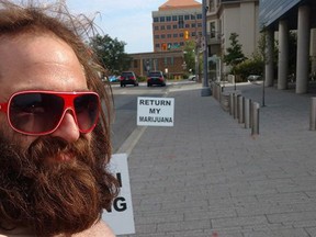 Jeffrey Shaver stands outside a Kitchener court house in this recent handout image. Shaver, 31, of Cambridge, Ont., was protesting outside a courthouse in Kitchener, Ont., demanding police return his medical marijuana and bong he says was seized in October. THE CANADIAN PRESS/HO-Jeffrey Shaver