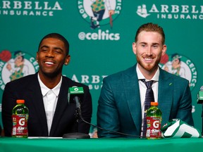 Boston Celtics’ Kyrie Irving, left, and Gordon Hayward laugh during a news conference in Boston, Friday, Sept. 1, 2017. (AP Photo/Winslow Townson)