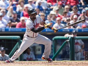 Atlanta Braves' Brandon Phillips puts the ball in play during the fifth inning of an MLB game against the Philadelphia Phillies on Aug. 30, 2017. (AP Photo/Chris Szagola)