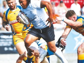 Toronto Wolfpack’s Fuifui Moimoi (centre) fights through Hemel Stags defenders in English rugby league action in July. (JACK BOLAND/TORONTO SUN FILE)