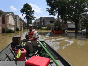 Volunteer rescuer Matt Clarke searches for local residents after a mandatory evacuation was ordered in the area beneath the Barker Reservoir as water is released, after Hurricane Harvey caused widespread flooding in Houston, Texas on August 31, 2017. MARK RALSTON/AFP/Getty Images
