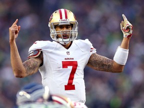 Colin Kaepernick of the San Francisco 49ers calls a play against the Seattle Seahawks during the 2014 NFC Championship at CenturyLink Field on January 19, 2014 in Seattle. (Ronald Martinez/Getty Images)