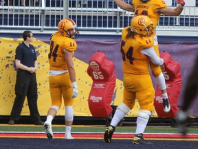 Queen’s Golden Gaels offensive lineman Daniel Hayes lifts receiver Matteo Del Brocco in celebration of a Del Brocco touchdown against the Carleton Ravens during the second half of Ontario University Athletics football action at Richardson Stadium last Saturday. (Steph Crosier/The Whig-Standard)
