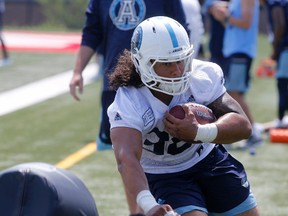 Toronto Argos fullback Declan Cross carries the ball during practice in Toronto, Ont. on Tuesday, August 1, 2017. (Michael Peake/Toronto Sun)