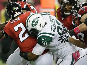 Atlanta Falcons quarterback Matt Ryan is sacked by New York Jets defensive end Sheldon Richardson during an NFL game on Oct. 7, 2013. (AP Photo/John Bazemore)