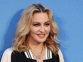 In this Sept. 15, 2016 file photo, Madonna poses for photographers upon arrival at the World premiere of the film "The Beatles, Eight Days a Week" in London. Madonna is heading overseas to a new home in Portugal. The Michigan native had been living in New York. She said on Instagram Saturday, Sept. 2, 2017 that she finds the energy of Portugal inspiring, and it makes her feel creative and alive. (AP Photo/Kirsty Wigglesworth, File)