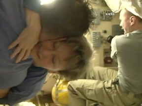 In this image from video made available by NASA, departing astronaut Peggy Whitson hugs Paolo Nespoli aboard the International Space Station during preparations for a return to Earth by her, Jack Fischer and cosmonaut Fyodor Yurchikhin on Saturday, Sept. 2, 2017. (NASA via AP)