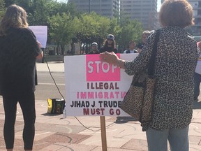 Around 30 people attended a rally outside Edmonton City Hall Saturday against proposed Access without Fear policies.