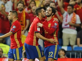 Spain’s Isco, right, celebrates after scoring the opening goal during the World Cup qualifying match at the Santiago Bernabeu Stadium in Madrid, Saturday Sept. 2, 2017. (AP Photo/Paul White)