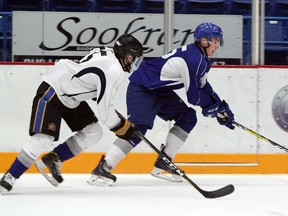 Blake Murray, right, speeds down the wing while Drew Wawrow chases him during the Sudbury Wolves' Blue and White Game at Sudbury Community Arena on Saturday. Ben Leeson/The Sudbury Star/Postmedia Network
