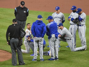 Teammates surround Blue Jays pitcher Marcus Stroman, facing camera, after he was hit by a line drive during a game against the Baltimore Orioles Saturday, Sept. 2, 2017, in Baltimore. (AP Photo/Gail Burton)