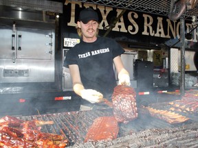Bowie Lynch from Texas Rangers prepares ribs during Downtown Sudbury Ribfest 2017. Ben Leeson/The Sudbury Star/Postmedia Network