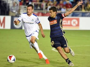 FC Edmonton midfielder Ben McKendry, left, plays the ball in front of North Carolina FC midfielder Nazmi Albadawi in North American Soccer League play at WakeMed Soccer Park in Cary, North Carolina on Saturday, Sept. 2, 2017