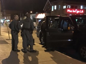 Tactical team members outside an apartment building on Somerset Street West Saturday night. They were investigating a home invasion.