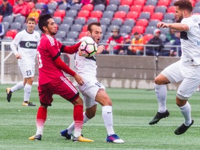 Saint Louis FC #18 Ivan Mirkovic (centre) and Ottawa Fury FC #10 Gerardo Bruna battle for the ball during USL action at TD Place in Ottawa on Sunday, Sept. 3, 2017. (Ashley Fraser/Postmedia)