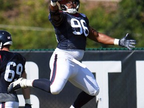 Eli Ankou (96) leaps for the ball during Texans training camp in White Sulphur Springs, W.Va., on Aug. 2, 2017. Ankou was claimed by the Jaguars on Sunday, Sept. 3, 2017. (Chris Tilley/AP Photo)