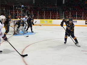 Owen Sound Attack centre Nick Suzuki, foreground left, was met by his younger brother Ryan Suzuki, far right, a centre with the Barrie Colts, as the elder Suzuki tried to get in position to take a shot on Colts netminder Kai Edmonds during an Ontario Hockey League exhibition game Sunday at the Harry Lumley Bayshore Community Centre. Denis Langlois/The Owen Sound Sun Times/Postmedia Network